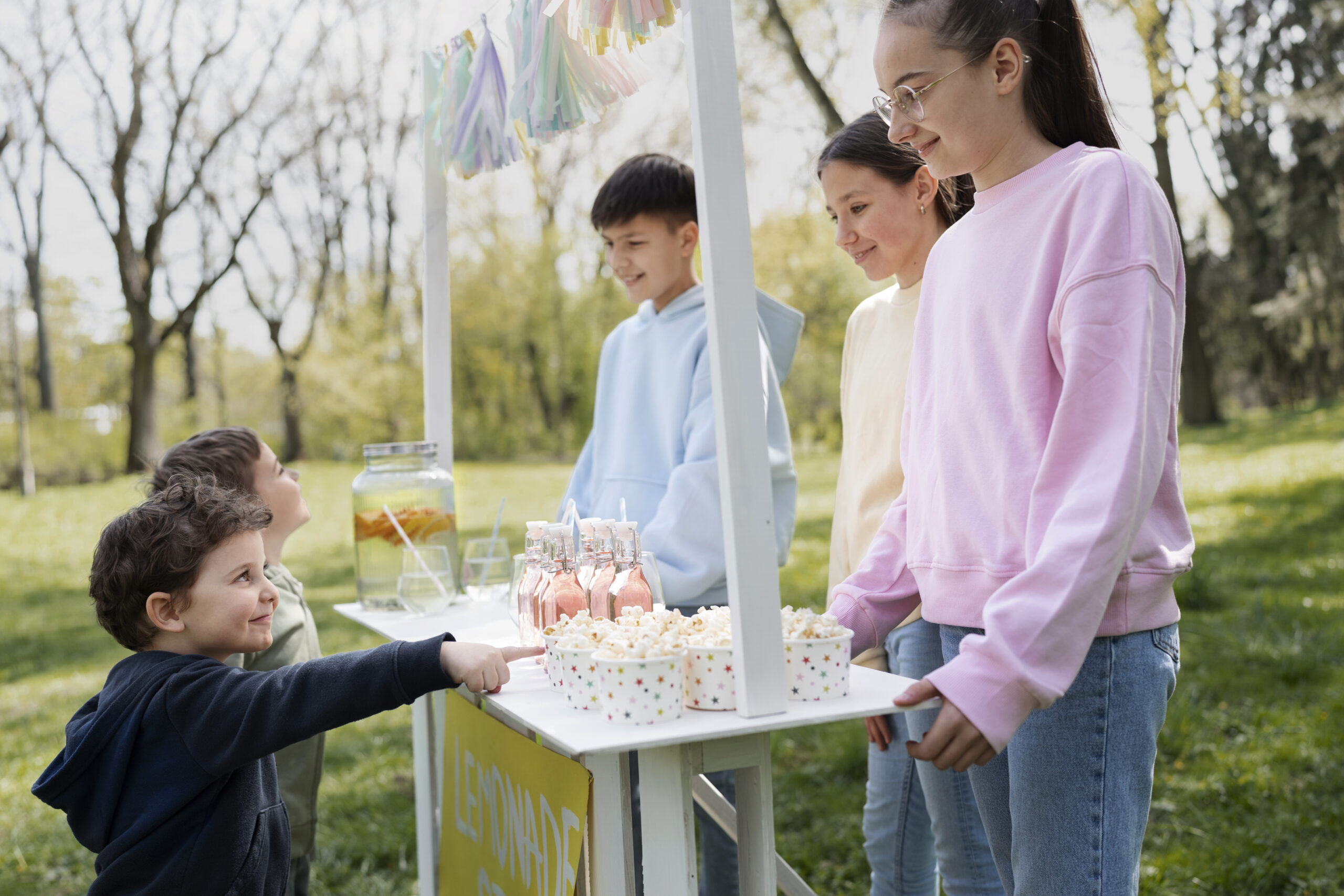 side-view-friends-selling-lemonade